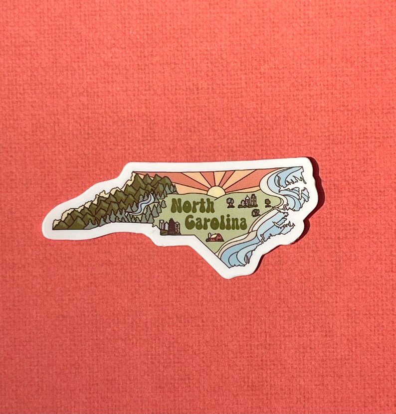 North Carolina sticker featuring Charlotte, Raleigh/Durham area, mountains, beaches, sunshine, and farms. Sticker is in the shape of NC with a white offset.
