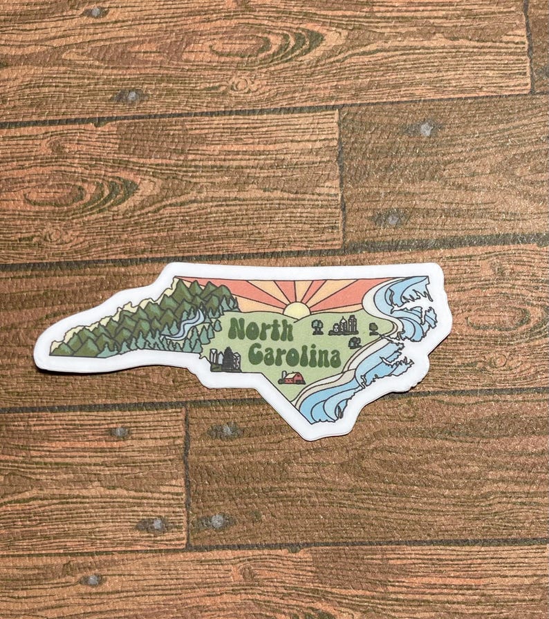 North Carolina sticker featuring Charlotte, Raleigh/Durham area, mountains, beaches, sunshine, and farms. Sticker is in the shape of NC with a white offset.