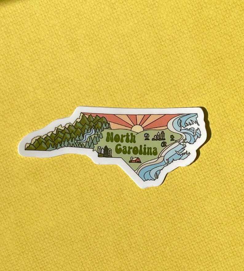 North Carolina sticker featuring Charlotte, Raleigh/Durham area, mountains, beaches, sunshine, and farms. Sticker is in the shape of NC with a white offset.