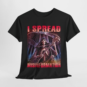 May include: Black t-shirt featuring a graphic of the Grim Reaper holding a scythe, with the text "I SPREAD MISINFORMATION" in red and white. The design includes a skeletal figure in a hooded cloak, set against a gothic background.