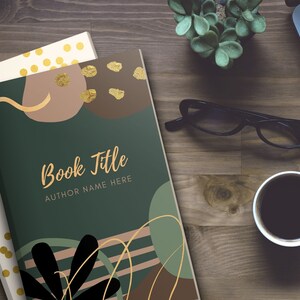 May include: A green book cover with a gold and brown abstract design. The text "Book Title" and "Author Name Here" is printed on the cover.