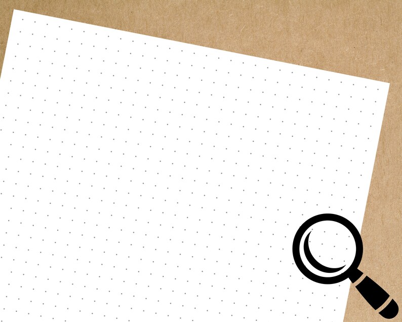 May include: A white sheet of paper with a black magnifying glass in the bottom right corner. The paper has a pattern of small black dots.