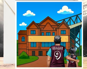 May include: A greeting card featuring an illustration of a parent and child in matching jerseys, standing in front of a stadium. The jerseys are maroon with teal accents and the number 9. The background includes a building and a blue sky with clouds.