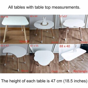 May include: Ten different wooden children's tables with white tops in various shapes, including square, round, clover, moon, cloud, and rectangle. The table tops are labeled with their dimensions in inches. The height of each table is 18.5 inches.