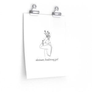 May include: Line art print of a woman with flowers growing from her head. The text "obstinate, headstrong girl" is below the image.