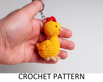 May include: A crocheted yellow chick keychain with a red comb and a silver key ring.
