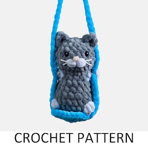 May include: A gray crocheted cat toy hanging from a blue rope swing.  CROCHET PATTERN is written below the image.