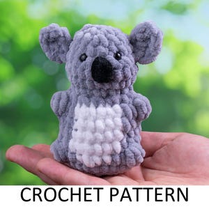 May include: A grey crocheted koala plush toy with a white belly, sitting in a hand against a green and blue blurred background. CROCHET PATTERN is written below the toy.