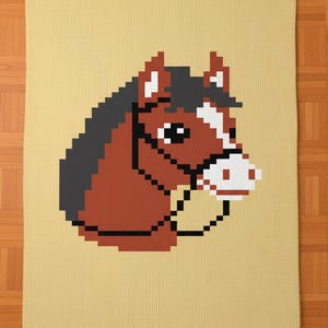 May include: A pixelated horse head design on a beige blanket. The horse is brown with a black mane and a white stripe on its face. The blanket has a textured appearance, suitable for home decor.