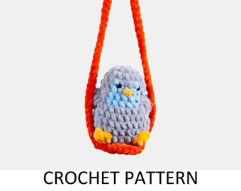 May include: A handmade crochet bird in a swing. The bird is gray with a blue chest and yellow feet. The swing and hanging cord are bright orange. The text "CROCHET PATTERN" is below the image.