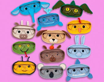 May include: A collection of 12 crocheted animal eyeglass holders. Each holder features a different animal, including an elephant, a fish, a cow, a dog, a snake, a bee, a koala, a shark, and a bunny. The holders are all made with soft yarn and have a cute and whimsical design.