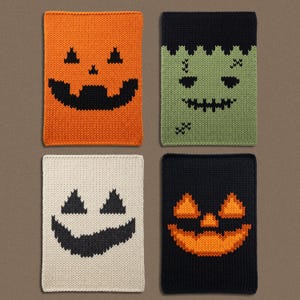 May include: Four rectangular knitted dishcloths featuring Halloween-themed designs. One is orange with a black jack-o'-lantern face, one is green with a black Frankenstein monster face, one is cream with a black ghost face, and one is black with an orange jack-o'-lantern face.