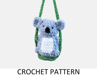 May include: A crocheted koala bear toy on a green swing. The koala is gray with a white belly and black eyes. The swing is made of green yarn.