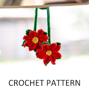 May include: Crochet pattern for a red and green flower car air freshener. The flowers are hanging from a rearview mirror.