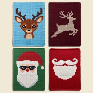 May include: Four rectangular knitted dishcloths featuring holiday designs. One is light blue with a brown reindeer face, one is dark red with a beige leaping reindeer, one is green with a Santa Claus face, and one is red with a white beard.