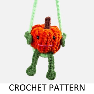 May include: A crocheted pumpkin with a smiling face and green leaves. The pumpkin is attached to a green yarn loop, making it a hanging ornament.