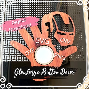 May include: A wooden hand with a cutout of Iron Man's face. The hand has a circle in the center with the words "SVG", "DXF", "PNG", and "CRV" around it. The text "Glowforge Button Decor" is at the bottom of the image.