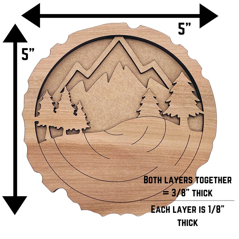 May include: A wooden wall art piece with a mountain and forest scene. The art is 5 inches in diameter and 3/8 inch thick. It is made of two layers of wood, each 1/8 inch thick.