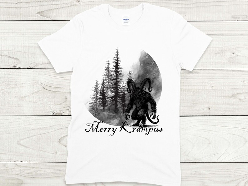 May include: White t-shirt with a black and white illustration of a Krampus figure standing in a forest with the text "Merry Krampus" below.