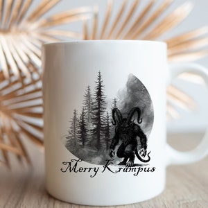 May include: White ceramic mug with a black and white illustration of a monster in a forest with the text "Merry Krampus".