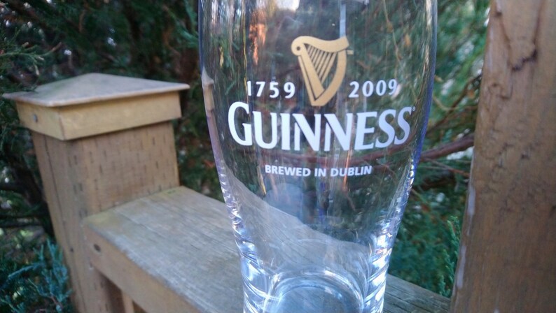 May include: A clear glass pint glass with the Guinness logo and the text "1759 GUINNESS 2009 Brewed in Dublin".