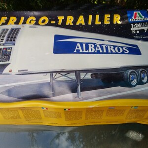 May include: A model kit box for a white and blue Albatros Frigo-Trailer, scale 1:24, with the number 791. The box is yellow and has text in multiple languages. The trailer has three axles and blue wheels.