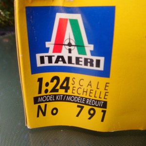 May include: A yellow box with the Italeri logo, featuring the Italian flag colors. The text reads "1:24 Scale Model Kit" and "No. 791". The box is for a model kit.