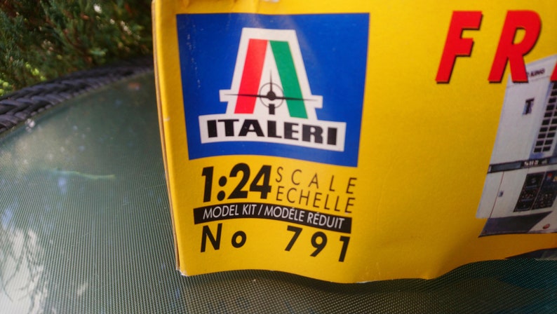 May include: A yellow box with the Italeri logo, featuring the Italian flag colors. The text reads "1:24 Scale Model Kit" and "No. 791". The box is for a model kit.