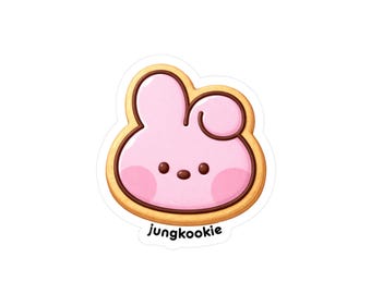 May include: A pink cartoon bunny cookie sticker with a brown outline and the word "jungkookie" in a white font. The bunny has a round head, two ears, and a small tail. The cookie has a light brown border.