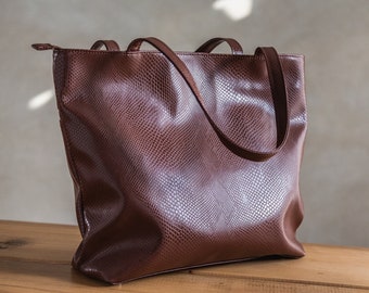 Brown embossed faux leather bag in snake pattern