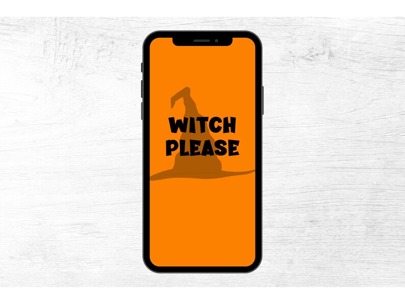 May include: A smartphone displays an orange background with a black witch hat silhouette and the words "WITCH PLEASE" in bold black letters. The phone is black and is set against a white wood grain background.