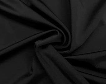 May include: Black fabric with a smooth, silky texture. The fabric is draped and folded, showing its drape and flow.