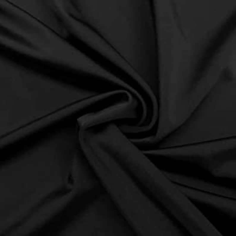 May include: Black fabric with a smooth, silky texture. The fabric is draped and folded, showing its drape and flow.
