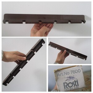May include: Brown plastic shelf bracket with six slots. The bracket is labeled "Art.No 7600 Rosti DENMARK".