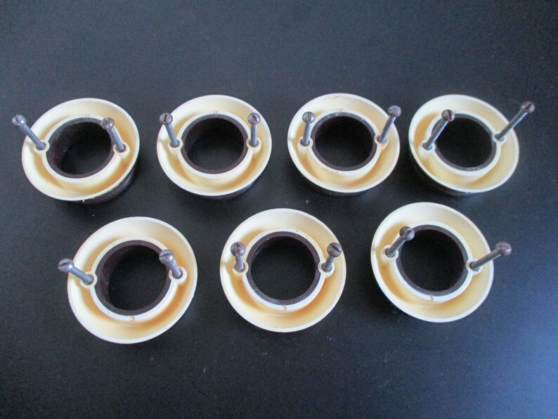 May include: Six white plastic rings with a brown inner ring and two screws on each ring.