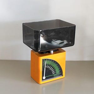 Orange Compact kitchen scales by EKS Sweden , designed by Bengt Ek , Orange kitchen scales ,EKS Sweden , Bengt Ek kitchen scales.