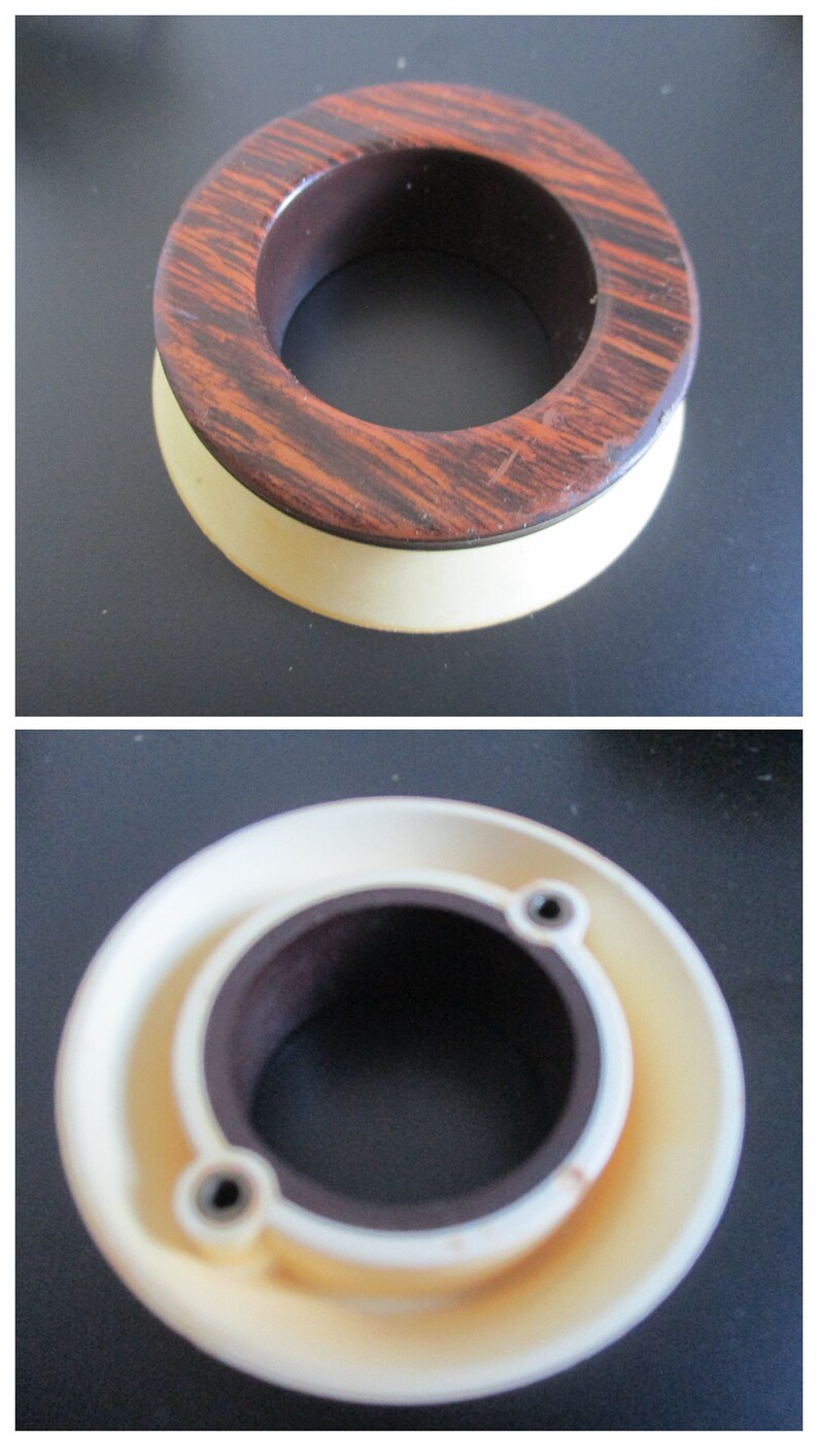 May include: A wooden ring with a brown and white pattern, with a smaller ring inside. The outer ring is made of wood and the inner ring is made of plastic.