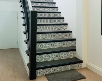 May include: A white and black tiled staircase with a black railing leading up to a white ceiling. The staircase is in a hallway with a white closet on the left and a window on the right.
