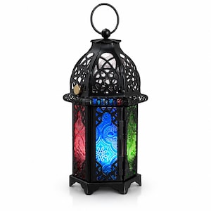 May include: A black metal lantern featuring a domed top with a circular hanging ring. The lantern has six sides with intricate cut-out patterns and panels of textured glass in vibrant red, blue, and green colors. A small gold-colored latch is visible.