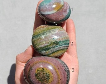 May include: Three polished stones with green, pink, and brown swirling patterns. The stones are numbered 1, 2, and 3.