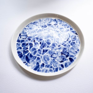 Handpaited plate with a motif inspired by the surface of flashing water, porcelain