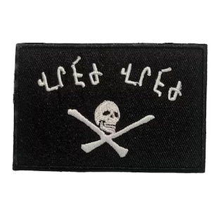 Puede incluir: Parche bordado negro con una calavera y huesos cruzados blancos y el texto "LIFE OR DEATH" en blanco.