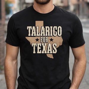 May include: Black t-shirt featuring the text "TALARICO FOR TEXAS" in a bold, vintage-style font. The design includes a tan outline of the state of Texas. The shirt is a classic crew neck style.