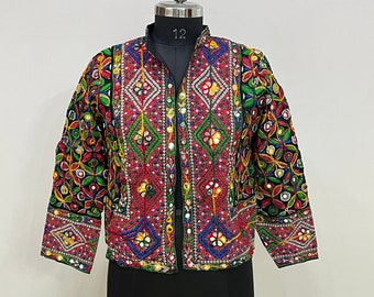 May include: A colorful embroidered jacket with mirror work and floral patterns. The jacket is black with red, green, blue, and yellow accents. The jacket has a mandarin collar and a button closure.