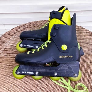 May include: Black and yellow inline rollerblades with the brand name "Rollerblade" printed on the side. The wheels are green and have the word "Lightning" printed on them. The size is marked as "44-10".
