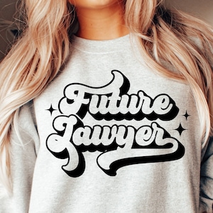 May include: A gray sweatshirt with the text "Future Lawyer" in a retro, black, stylized font.