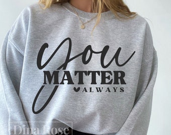 以下が含まれることがあります： グレーのトレーナーに、黒い文字で「you matter always」と書いてあります。テキストは筆記体で、「always」の前にハートマークがあります。