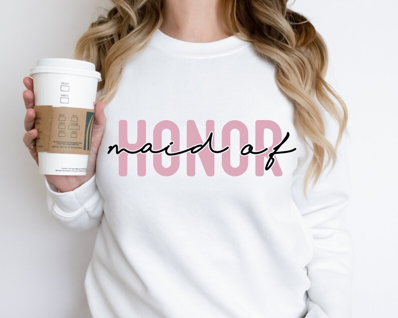 May include: White sweatshirt with the text "HONOR maid of" in pink letters with black script.