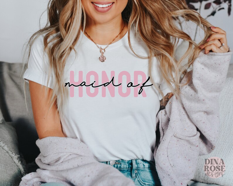 May include: A white t-shirt with the text "honor maid of" in black lettering with the word "maid" in pink.