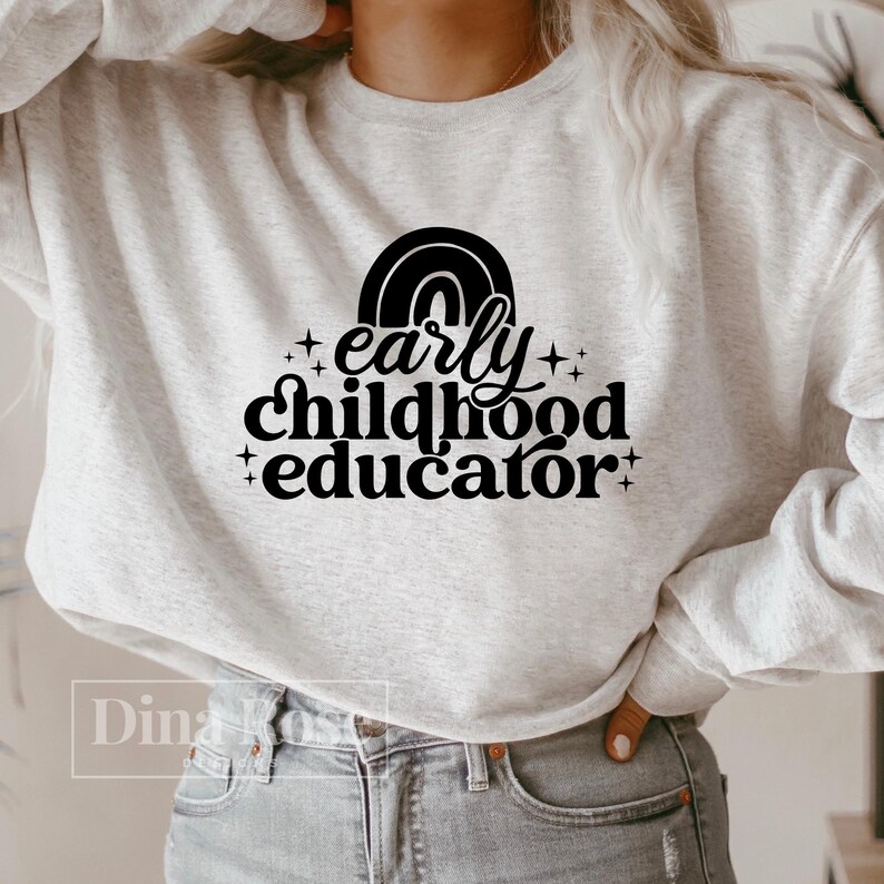 May include: A gray sweatshirt with a rainbow graphic and the text "early childhood educator" in black.